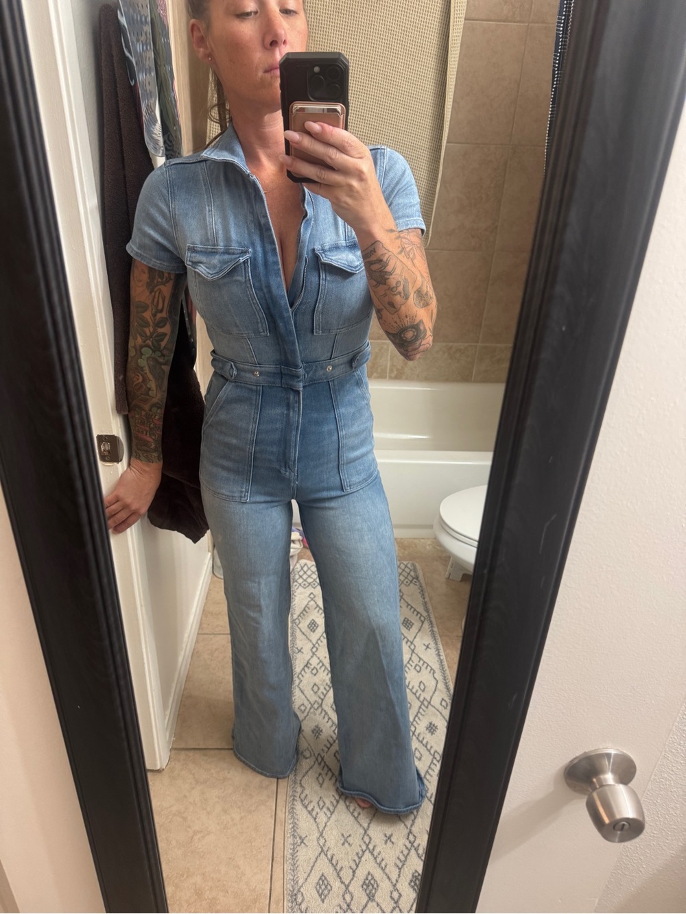 Good American Light Blue Denim Jumpsuit with Flared Legs and Chest Pockets